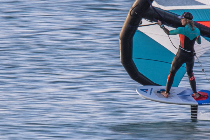 a person riding a surf board on a body of water