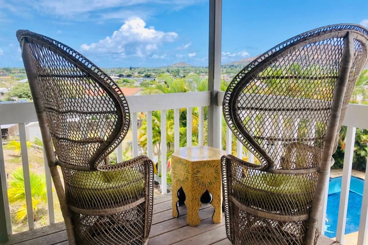 a chair sitting in front of a fence