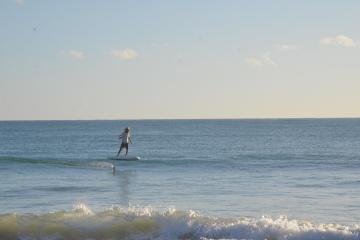 a man riding a wave on a surfboard in the ocean